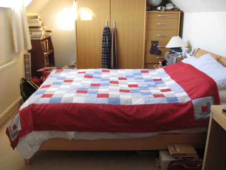 Finished quilt on bed (on top of regular duvet)